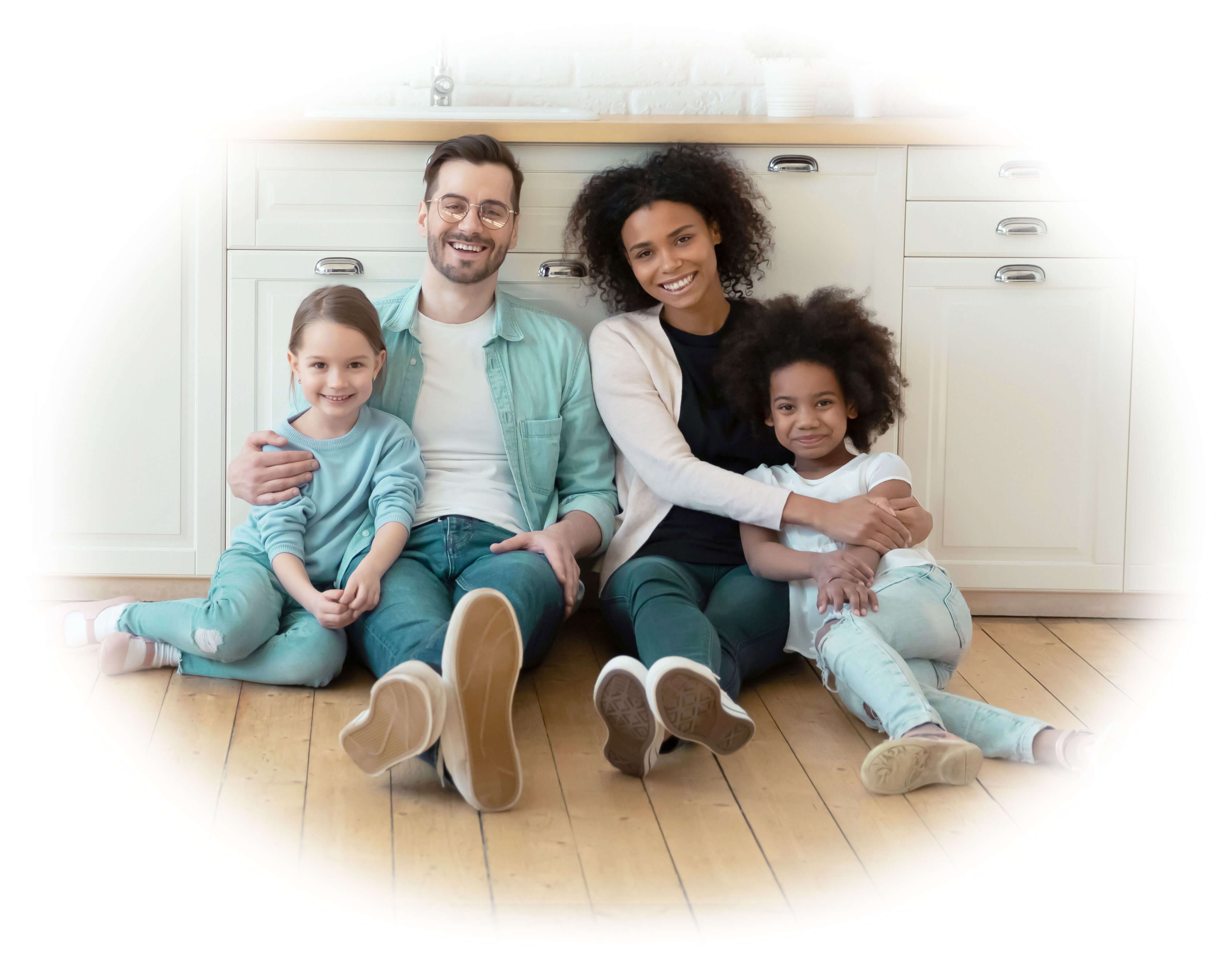 happy family sitting on the kitchen floor